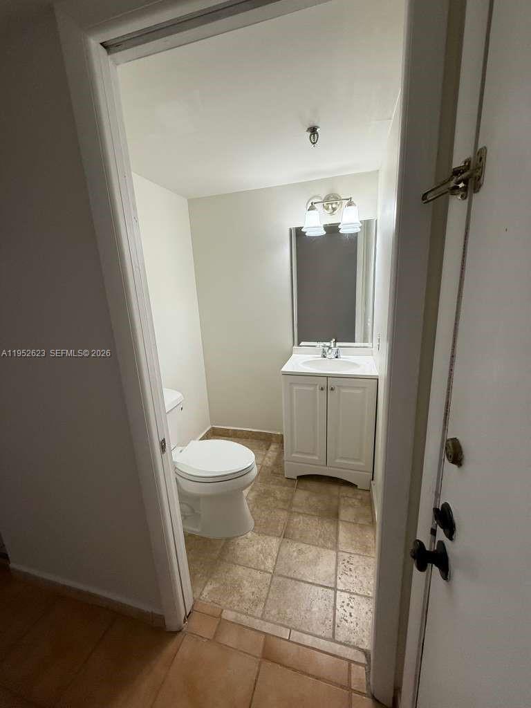 10641 Southwest 108th Avenue, Unit 3I Miami, FL 33176 - Photo 11 of 25 a bathroom with a toilet sink and mirror