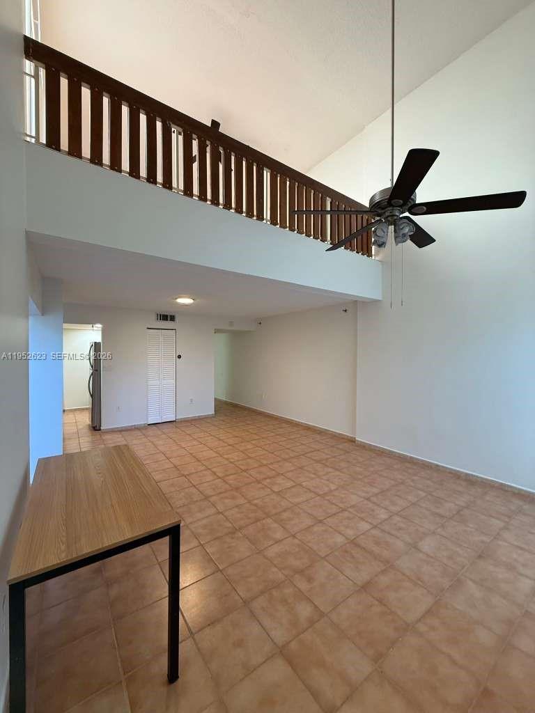 10641 Southwest 108th Avenue, Unit 3I Miami, FL 33176 - Photo 12 of 25 a view of an empty room and with a chandelier