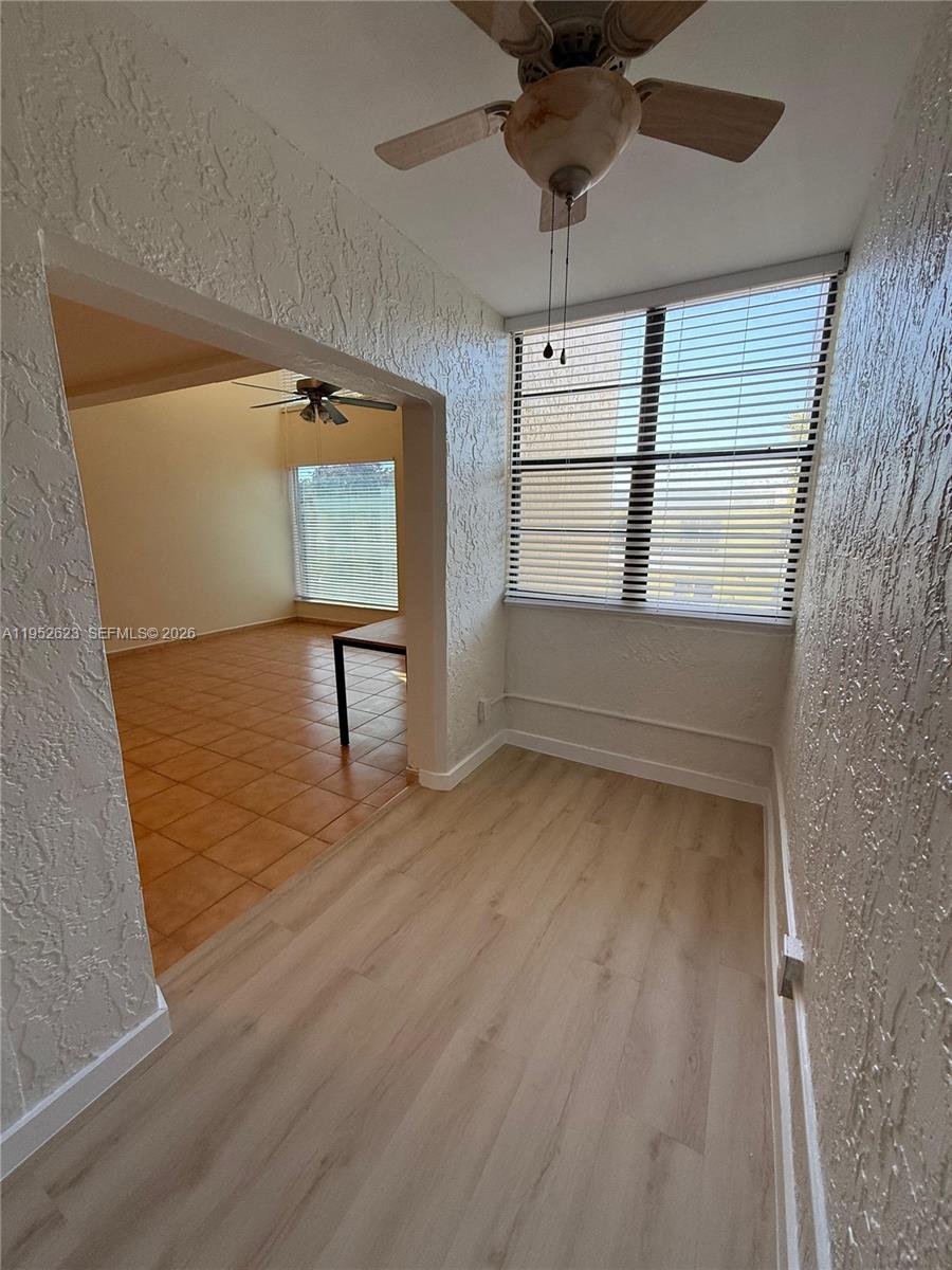 10641 Southwest 108th Avenue, Unit 3I Miami, FL 33176 - Photo 17 of 25 wooden floor in an empty room with a window
