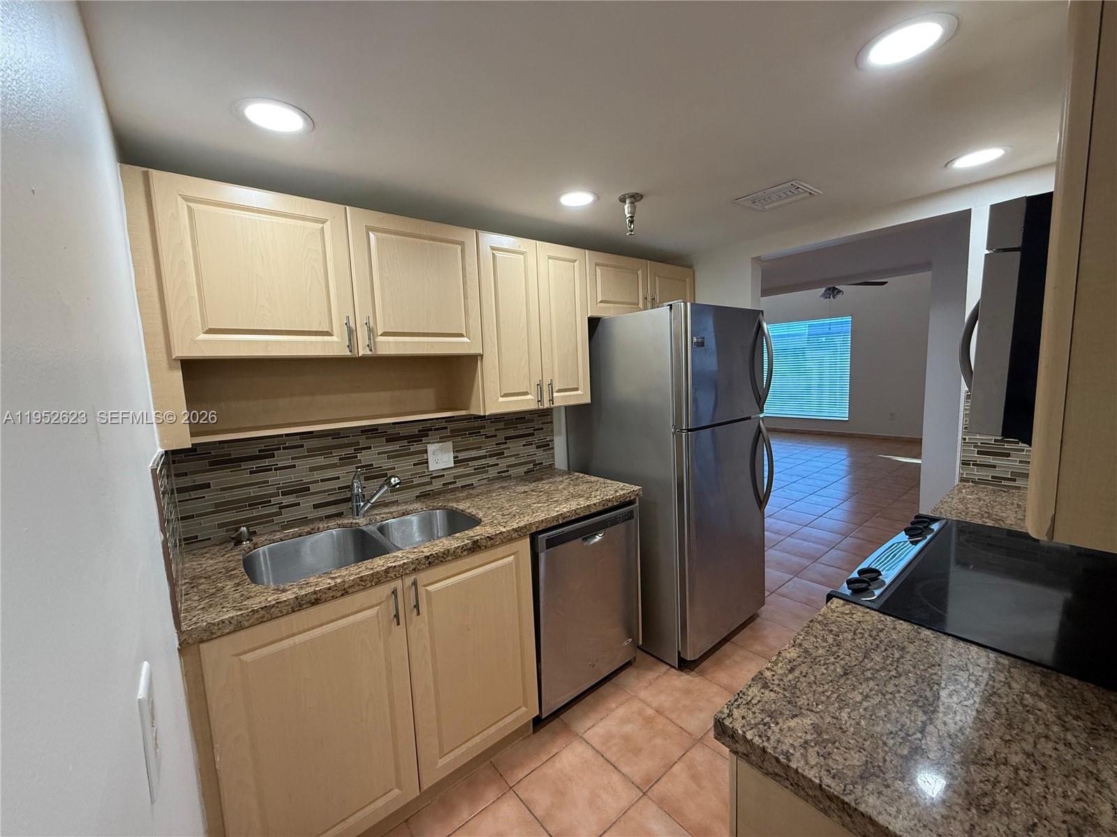 10641 Southwest 108th Avenue, Unit 3I Miami, FL 33176 - Photo 2 of 25 a kitchen with stainless steel appliances granite countertop a refrigerator stove and sink