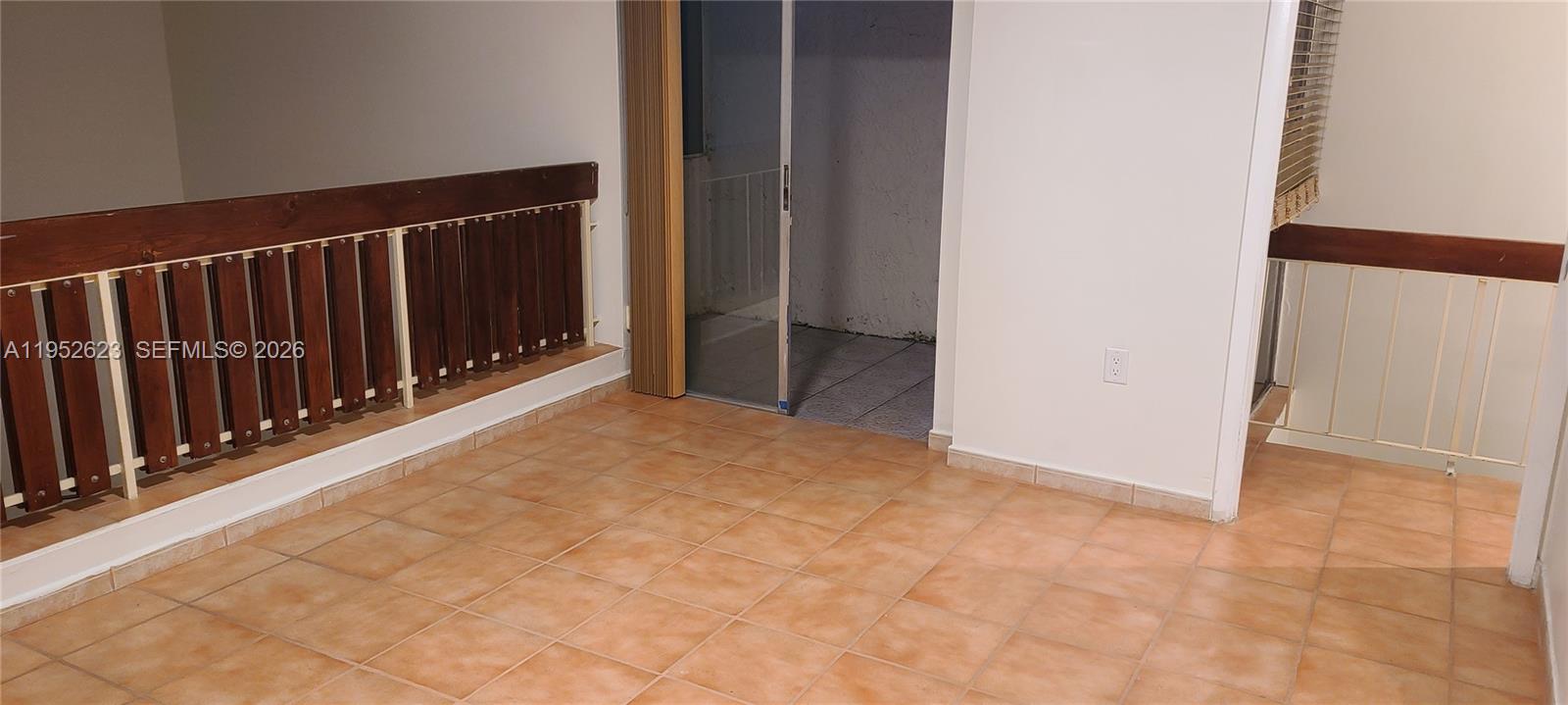 10641 Southwest 108th Avenue, Unit 3I Miami, FL 33176 - Photo 4 of 16 a view of an empty room with wooden floor