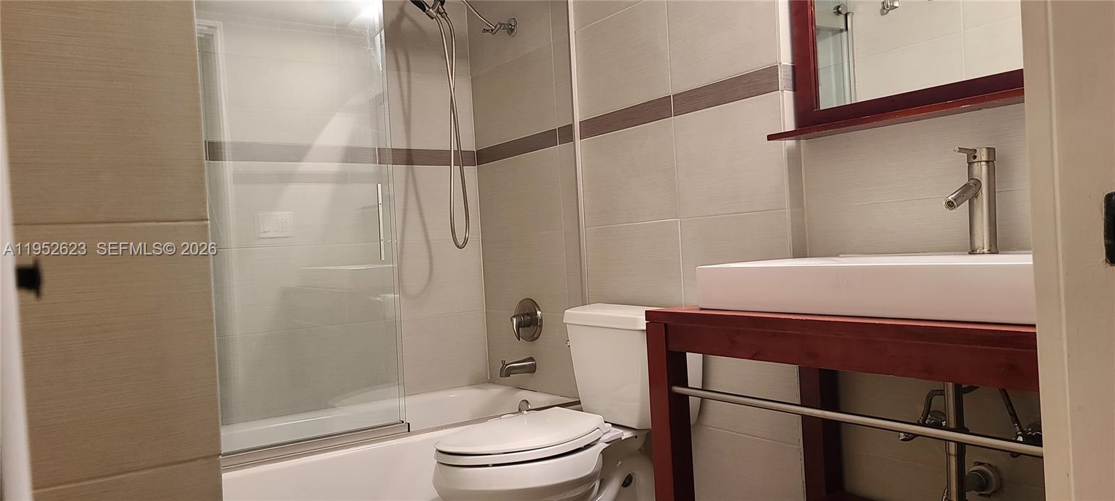 10641 Southwest 108th Avenue, Unit 3I Miami, FL 33176 - Photo 6 of 16 a bathroom with a toilet and a shower