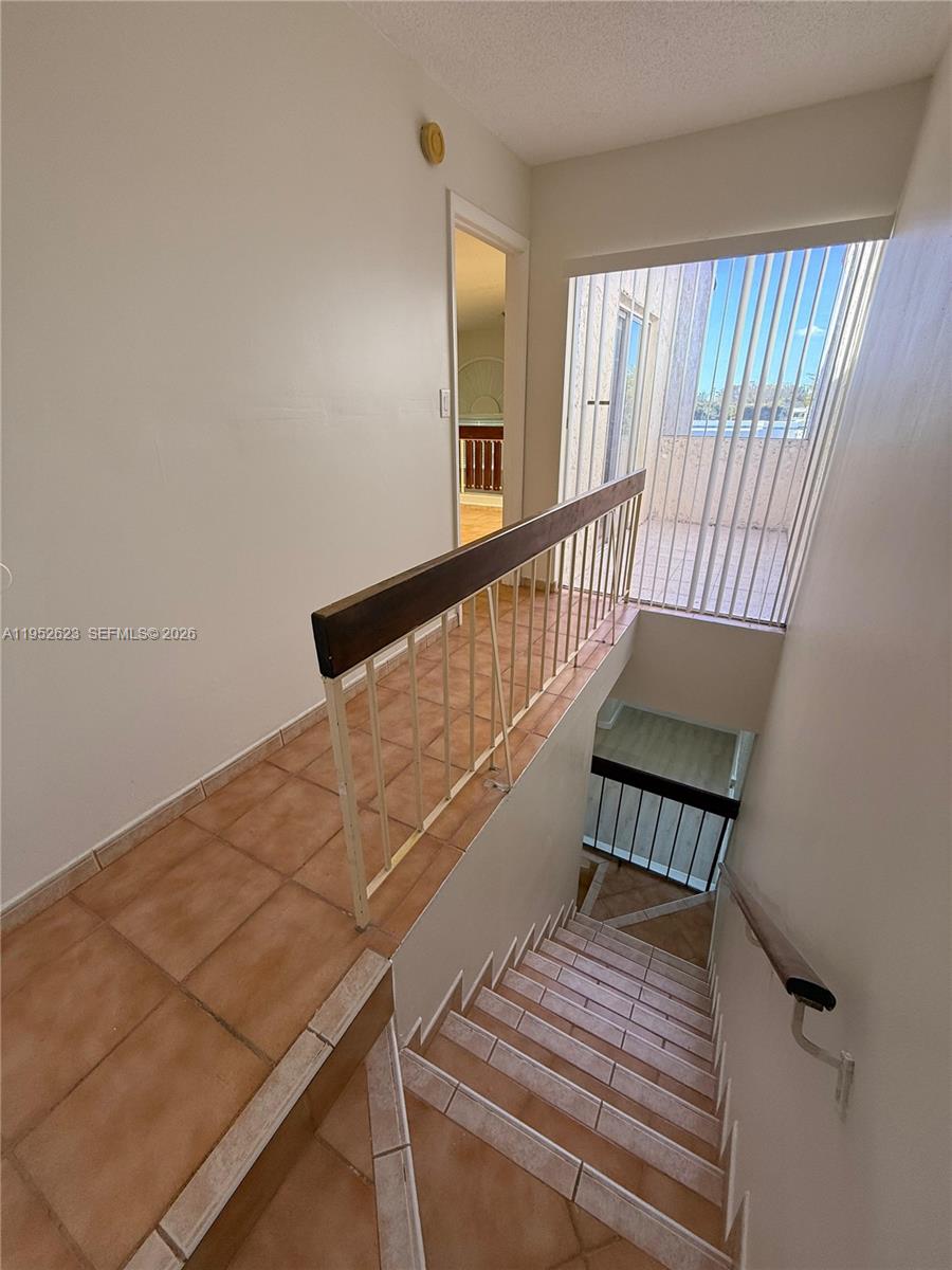 10641 Southwest 108th Avenue, Unit 3I Miami, FL 33176 - Photo 8 of 25 a view of wooden staircase