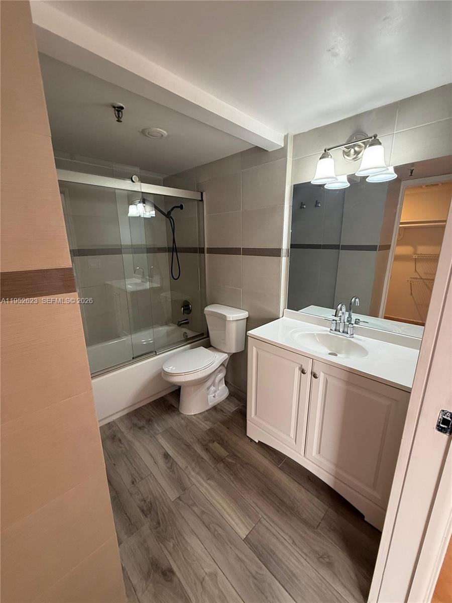 10641 Southwest 108th Avenue, Unit 3I Miami, FL 33176 - Photo 10 of 25 a bathroom with a sink a toilet and shower
