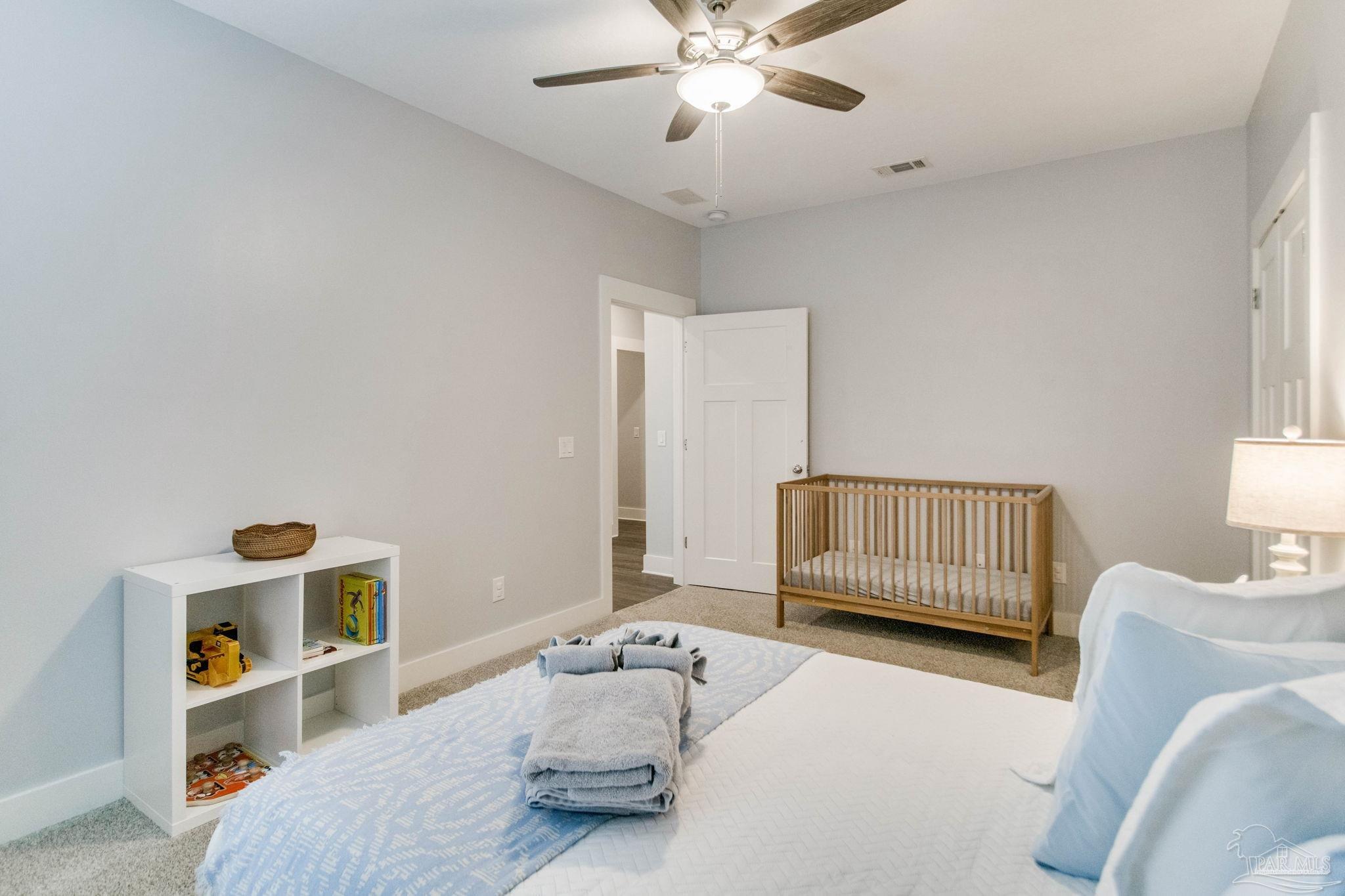 8245 Verano Street Navarre, FL 32566 - Photo 14 of 72 a bedroom with a bed and a window