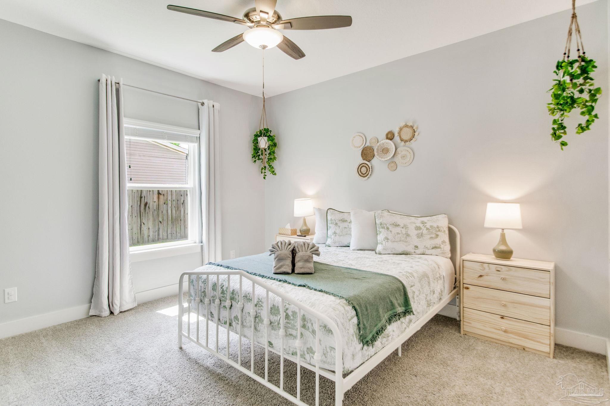 8245 Verano Street Navarre, FL 32566 - Photo 15 of 72 a bedroom with a bed and a window