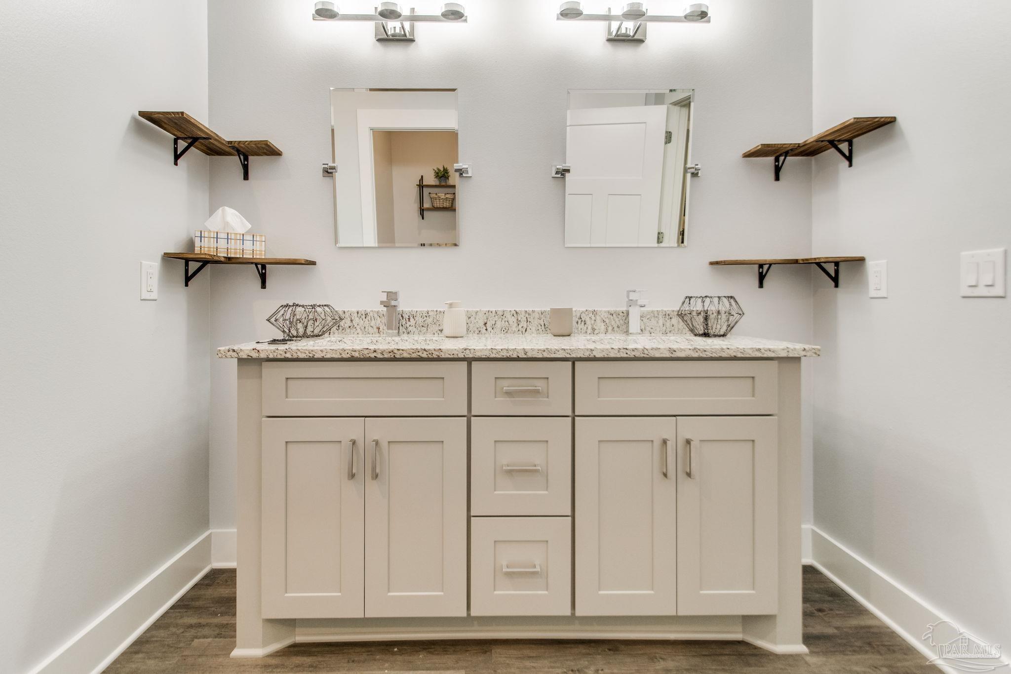8245 Verano Street Navarre, FL 32566 - Photo 22 of 72 a bathroom with a sink and a mirror