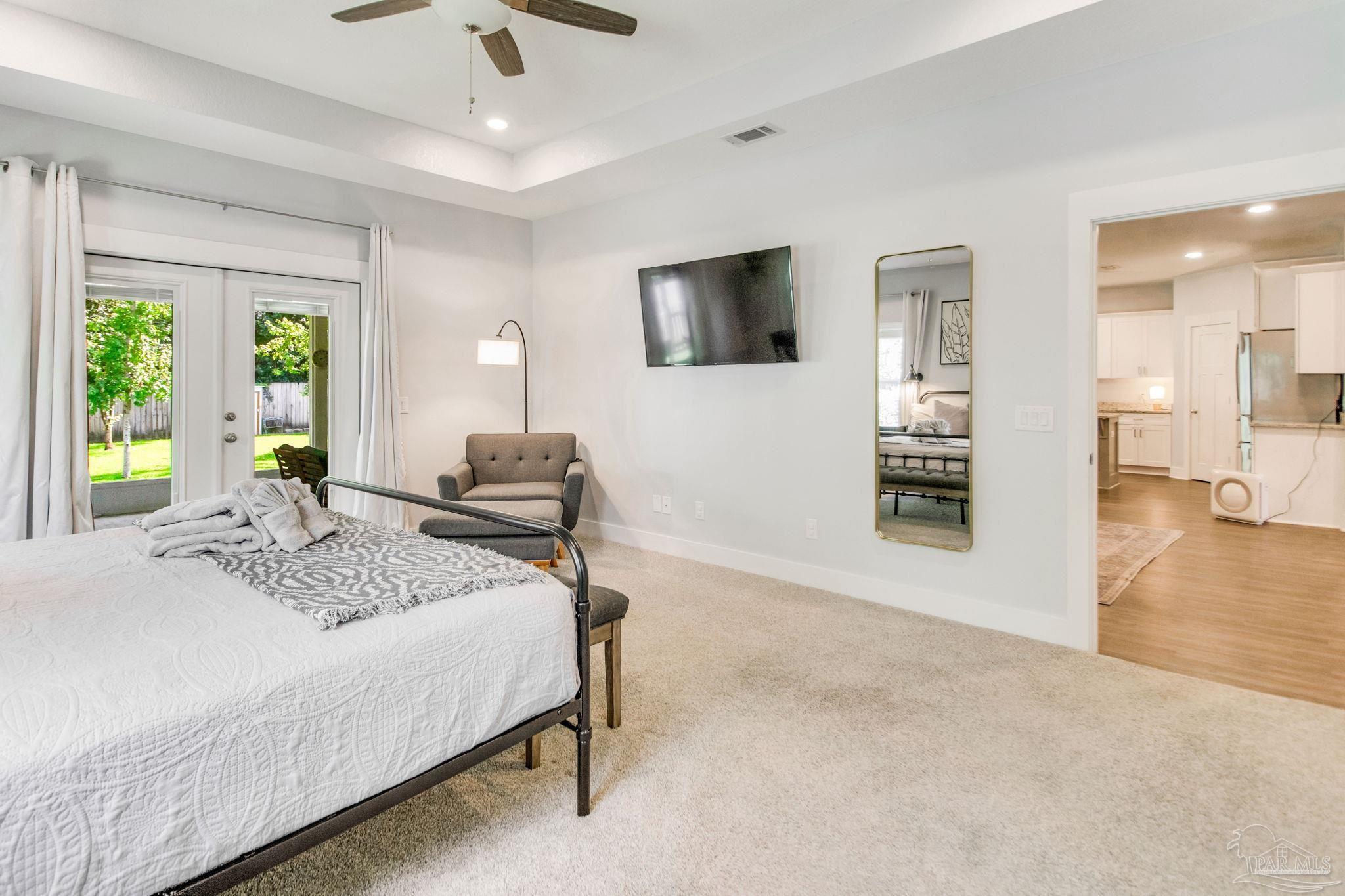 8245 Verano Street Navarre, FL 32566 - Photo 28 of 72 a bedroom with a large bed a flat tv screen and dresser