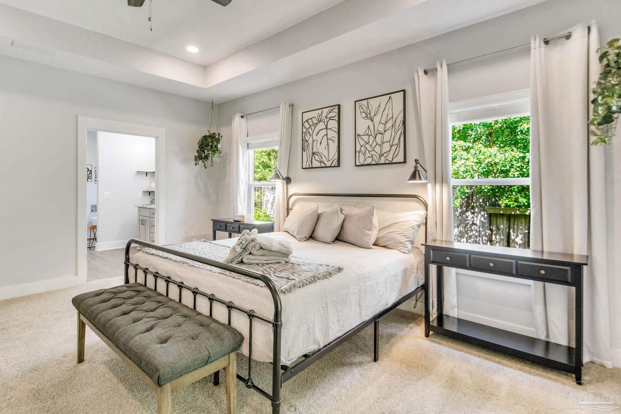 8245 Verano Street Navarre, FL 32566 - Photo 30 of 72 a bedroom with a bed and a dresser next to a window