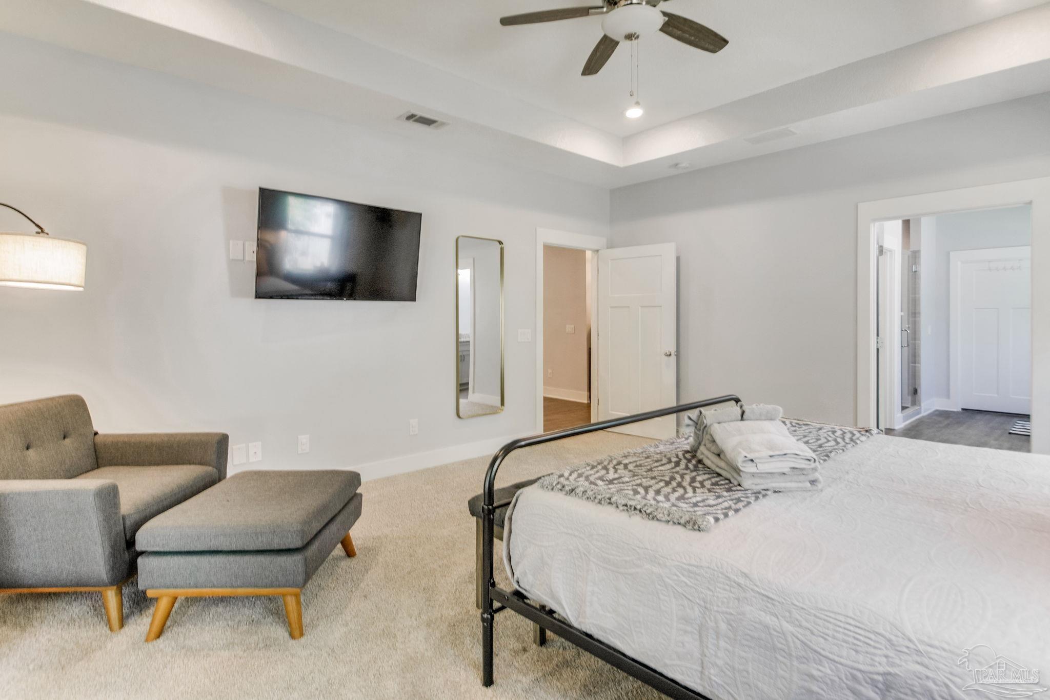 8245 Verano Street Navarre, FL 32566 - Photo 31 of 72 a bedroom with a bed and a flat screen tv