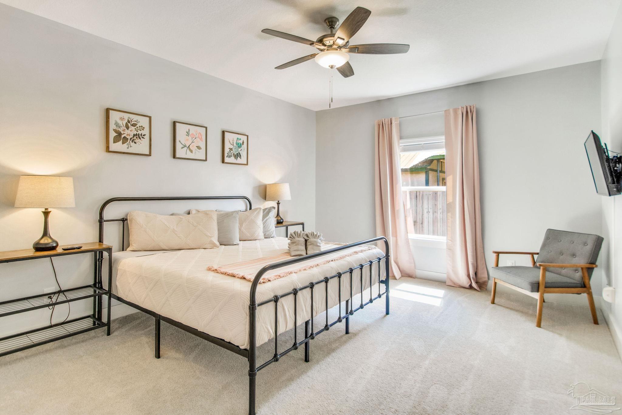 8245 Verano Street Navarre, FL 32566 - Photo 32 of 72 a bedroom with a bed and a window