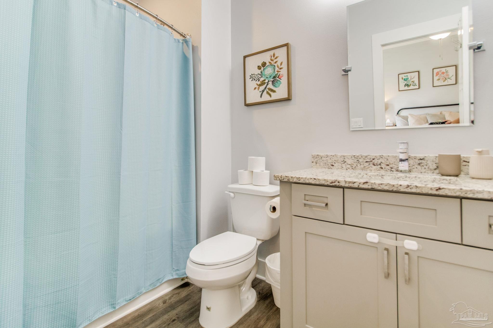 8245 Verano Street Navarre, FL 32566 - Photo 36 of 72 a bathroom with a granite countertop toilet sink and mirror