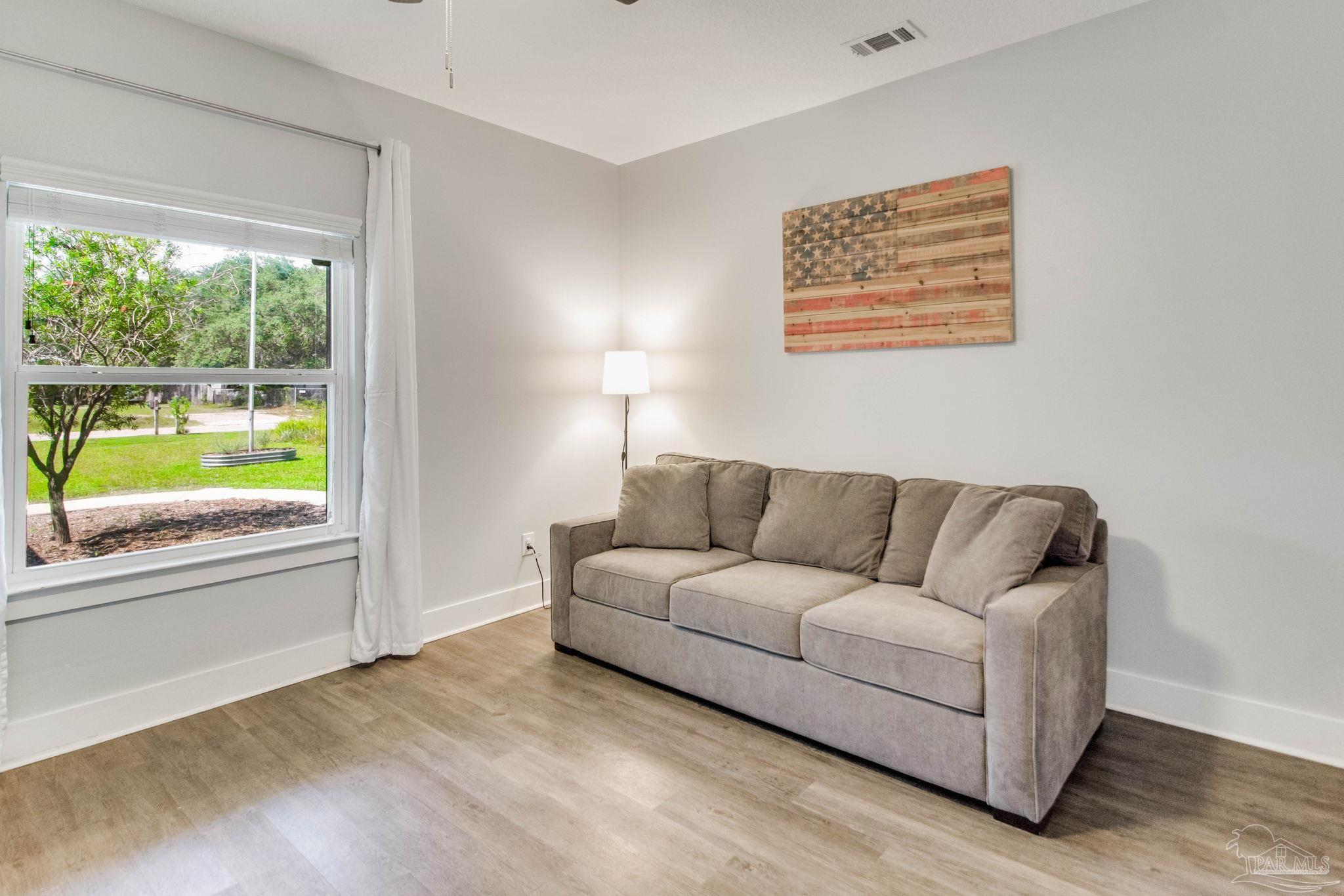 8245 Verano Street Navarre, FL 32566 - Photo 41 of 72 a living room with furniture and a window