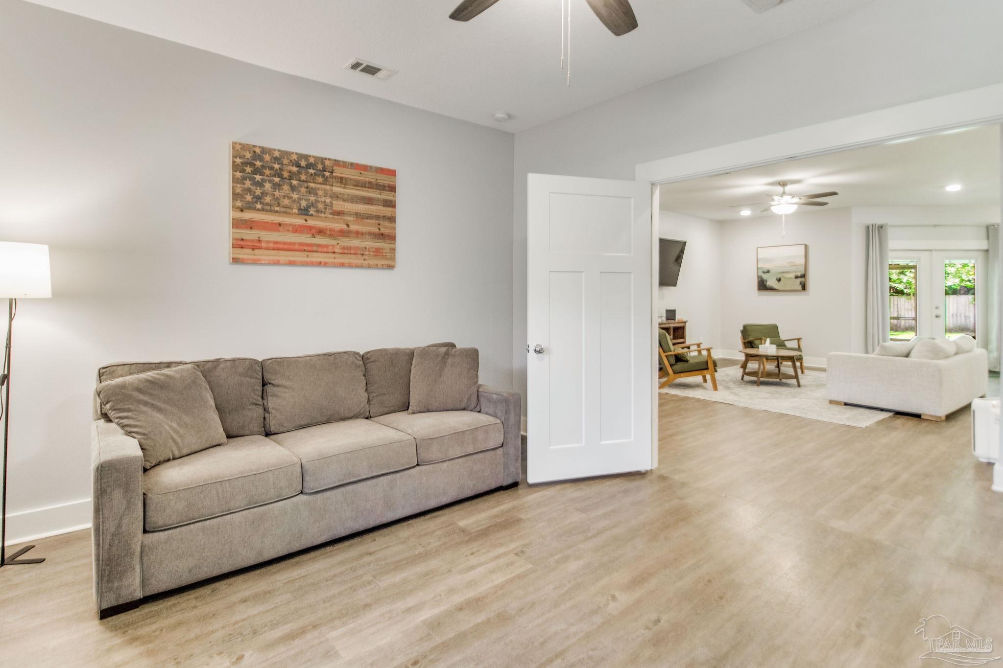 8245 Verano Street Navarre, FL 32566 - Photo 44 of 72 a living room with furniture and a large window