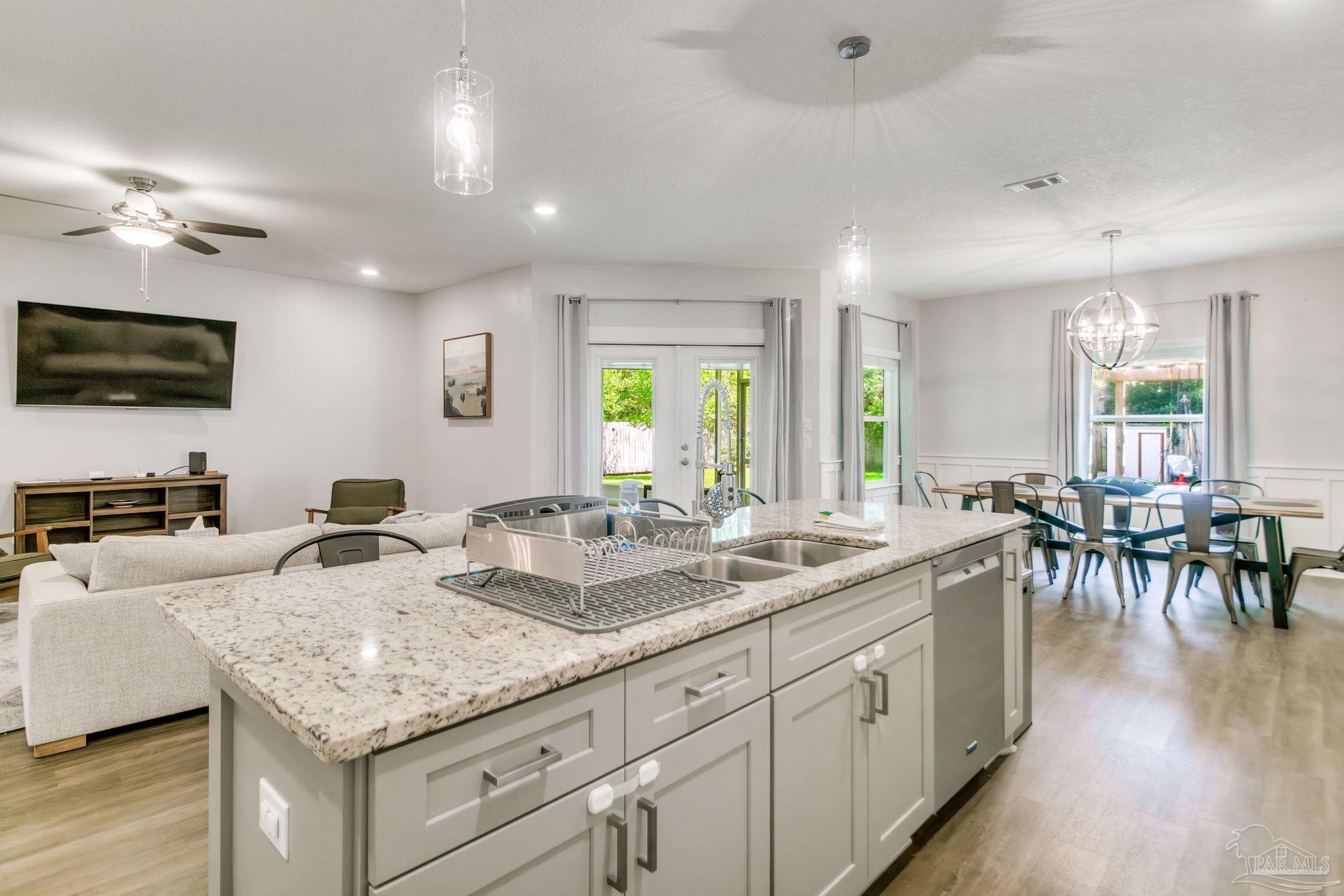8245 Verano Street Navarre, FL 32566 - Photo 48 of 72 a kitchen with granite countertop lots of counter top space and living room