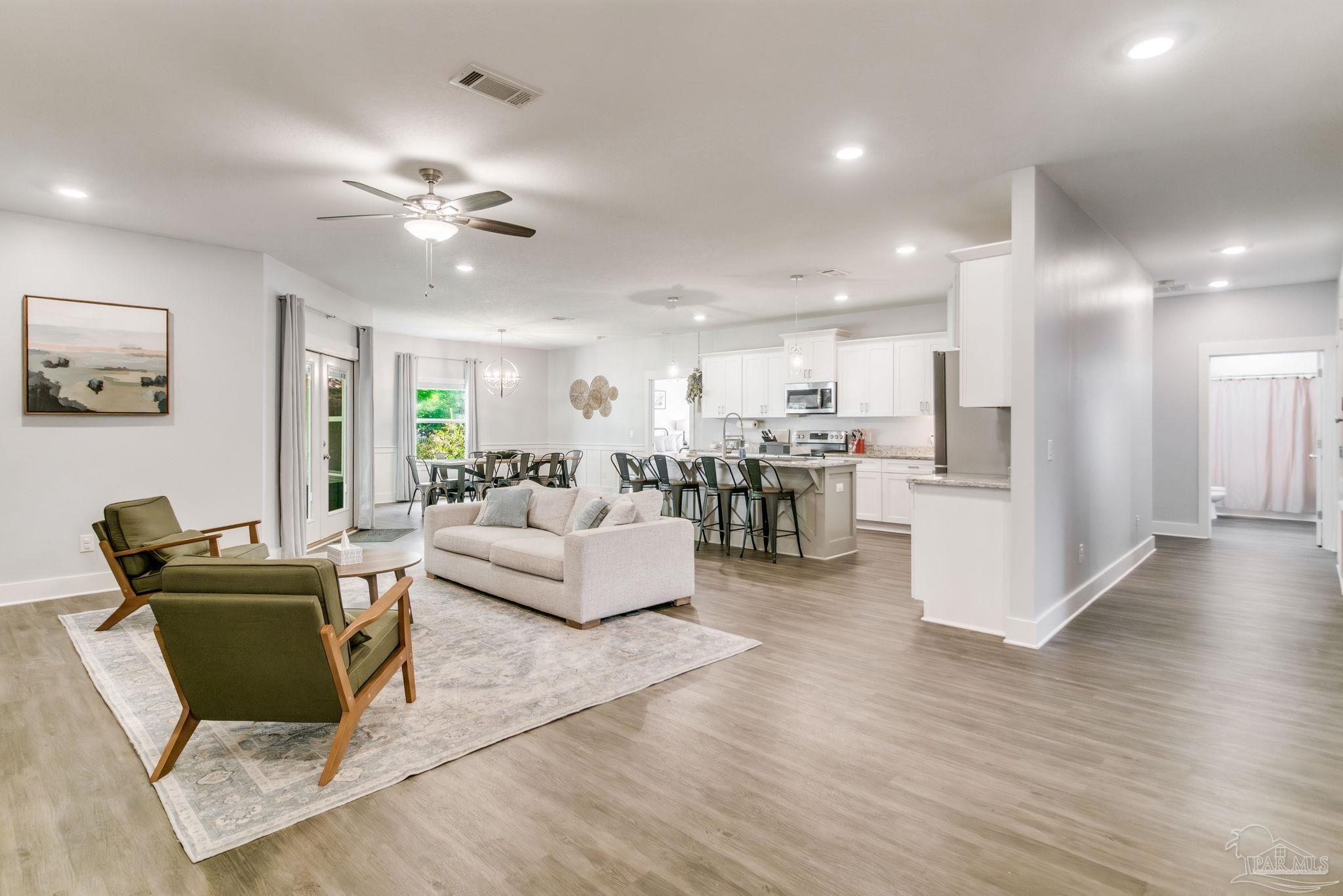 8245 Verano Street Navarre, FL 32566 - Photo 49 of 72 a living room with furniture and kitchen view