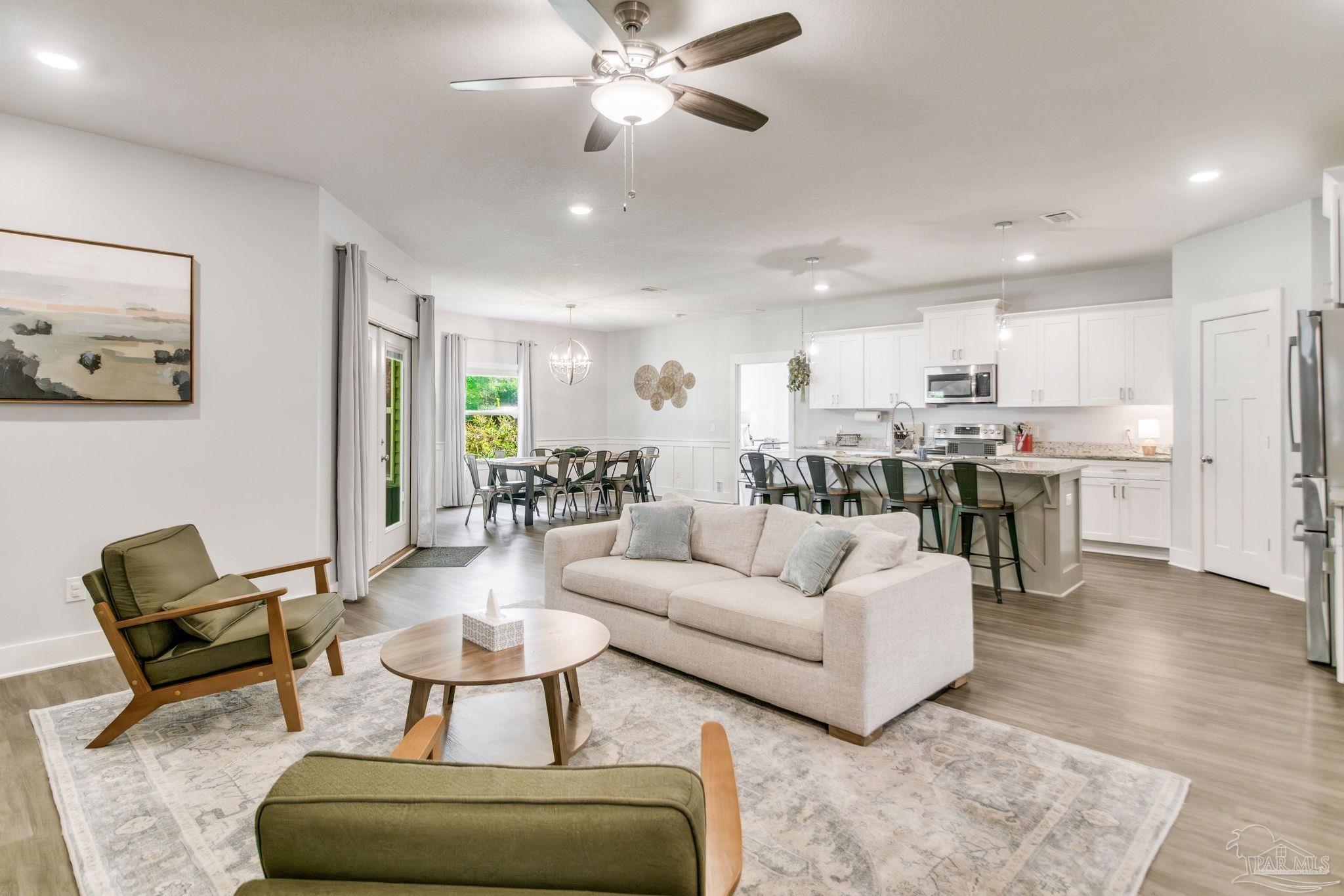 8245 Verano Street Navarre, FL 32566 - Photo 50 of 72 a living room with furniture and kitchen view