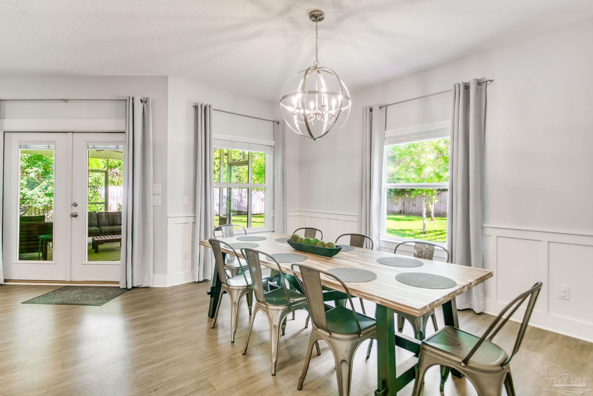 8245 Verano Street Navarre, FL 32566 - Photo 56 of 72 a view of a dining room with furniture window and outside view