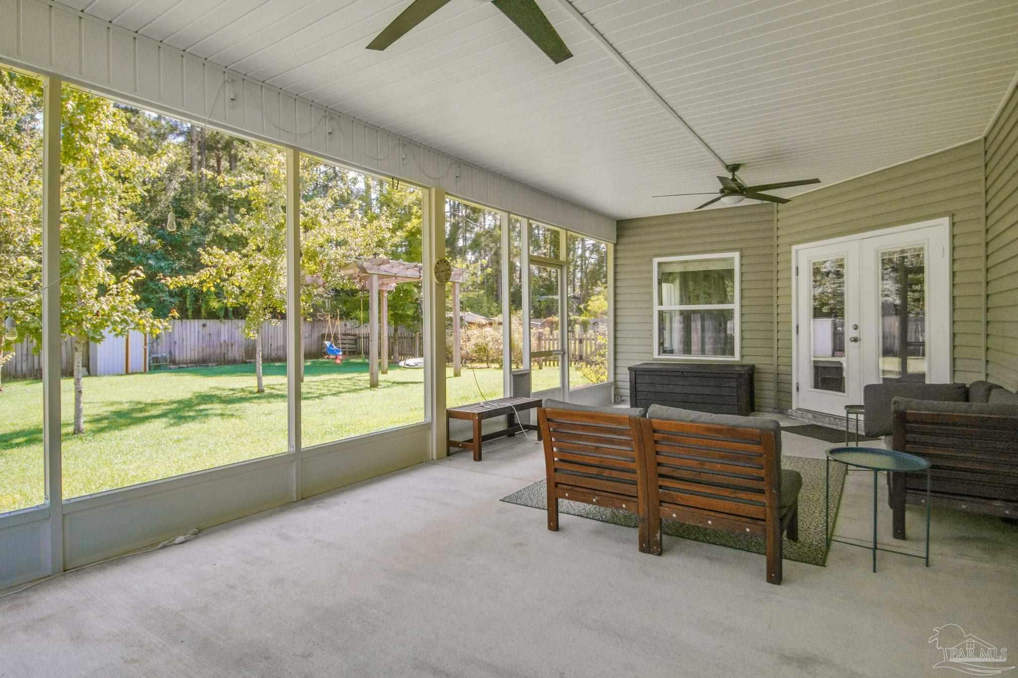 8245 Verano Street Navarre, FL 32566 - Photo 62 of 72 a living room with furniture and balcony view