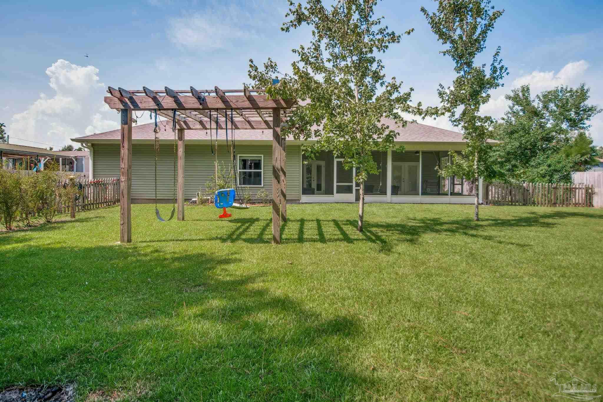 8245 Verano Street Navarre, FL 32566 - Photo 69 of 72 a view of a house with a yard and sitting area