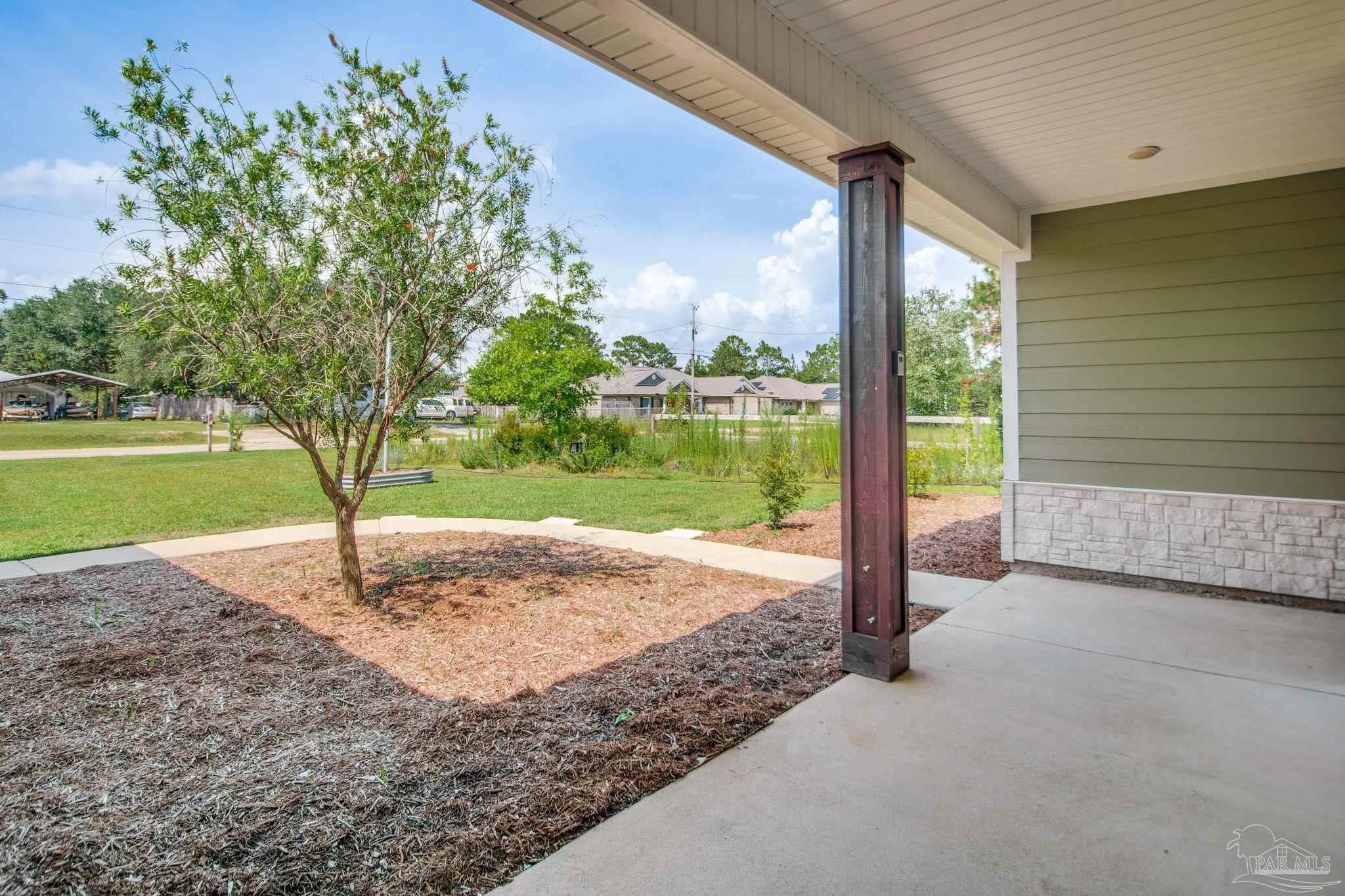 8245 Verano Street Navarre, FL 32566 - Photo 9 of 72 a view of a garden with an outdoor space
