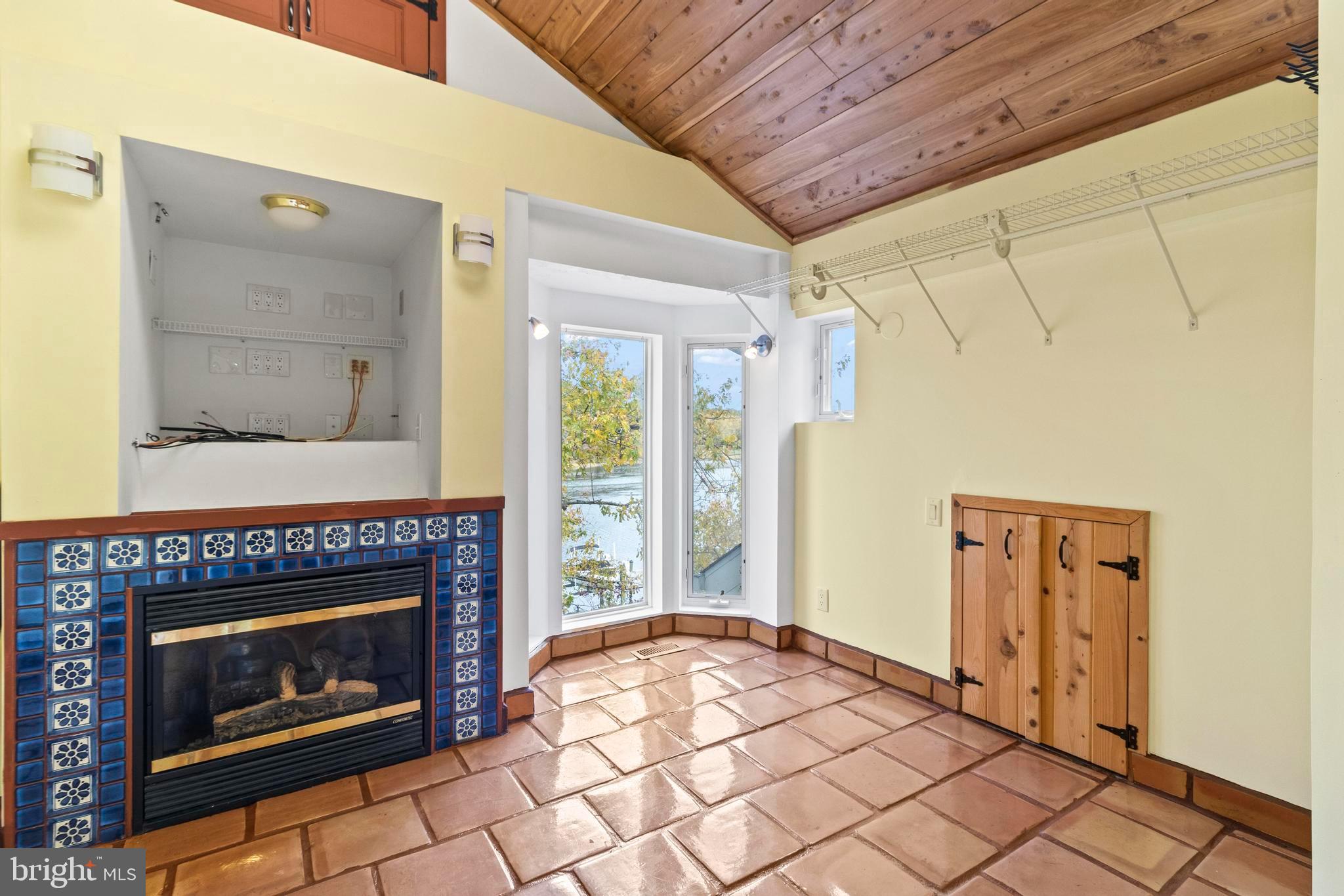12330 Potomac View Road Newburg, MD 20664 - Photo 41 of 85 a living room with a fireplace and a table