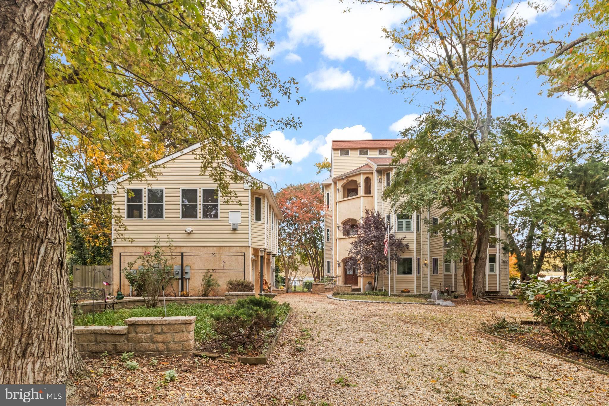 12330 Potomac View Road Newburg, MD 20664 - Photo 84 of 85 a view of a large white house with a yard and large trees