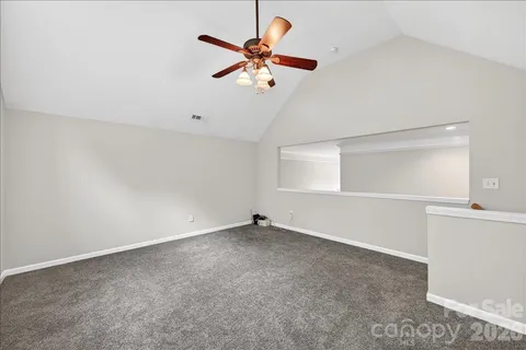 an empty room with closet and windows