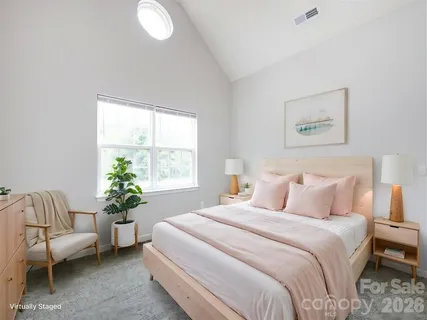 a bedroom with a bed and a couch