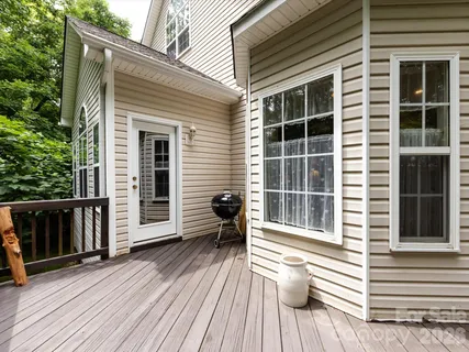a view of a deck with wooden floor and floor to ceiling window
