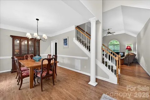 a dining room with furniture entryway and wooden floor