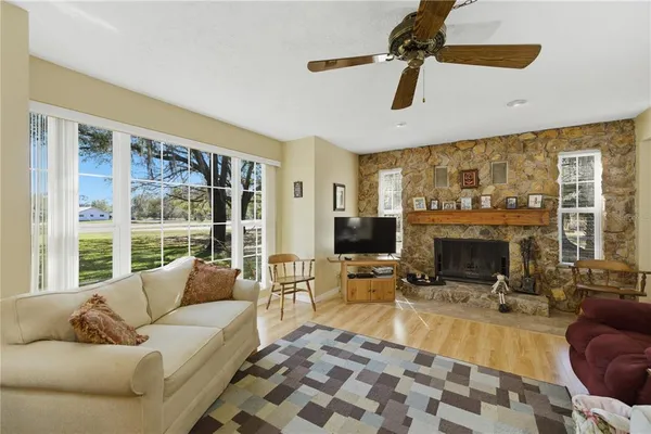 a living room with furniture tv and a fireplace