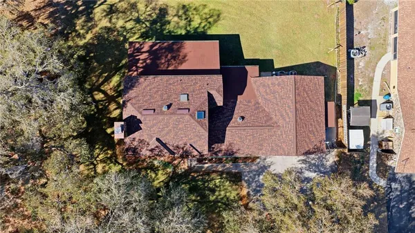 an aerial view of a house with a yard