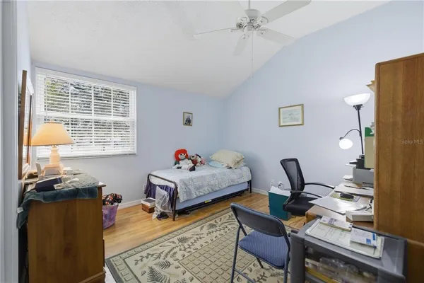 a bedroom with furniture and a window