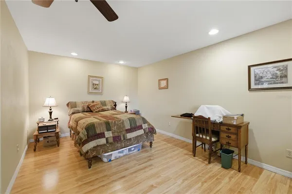 a spacious bedroom with a bed and a desk