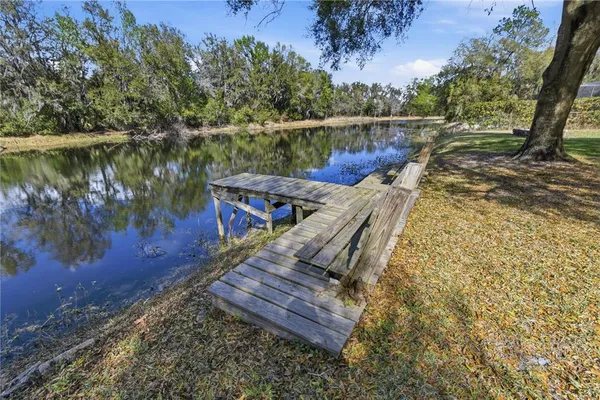 a view of a wooden deck with lake view