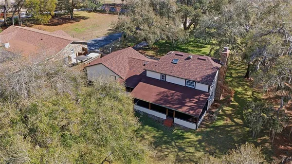 an aerial view of a house with a yard basket ball court and outdoor seating