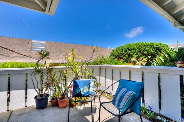 a view of balcony with chairs and potted plants