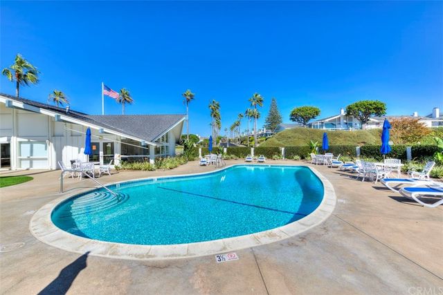 a front view of house with yard and trees in the background