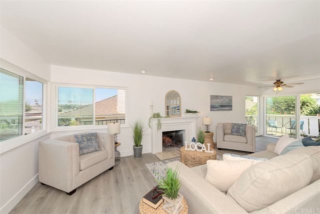 a living room with furniture fireplace and a large window