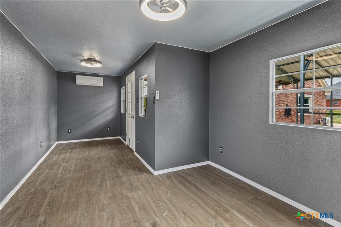 283 County Road 4710 Kempner, TX 76539 - Photo 44 of 47 a view of an empty room with wooden floor and a window