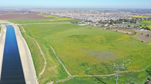 a view of a field with an ocean