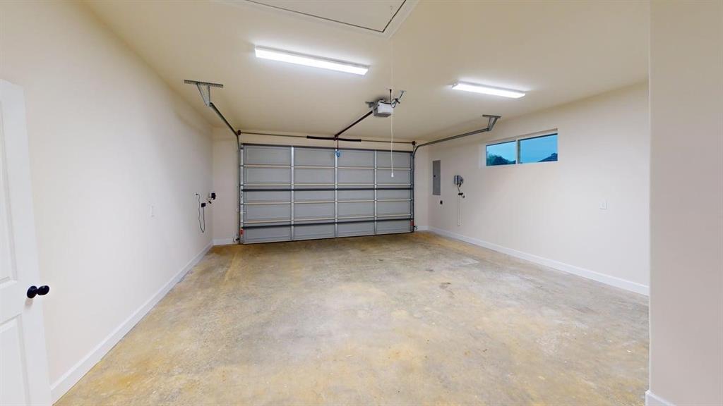2509 Windmill Lane Longview, TX 75601 - Photo 32 of 35 Garage with electric panel and a garage door opener