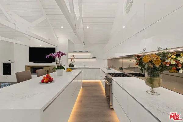 a kitchen with a sink appliances and cabinets