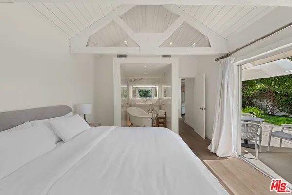 a bedroom with a large bed and a large window