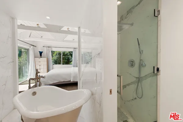 a bathroom with a tub shower and sink