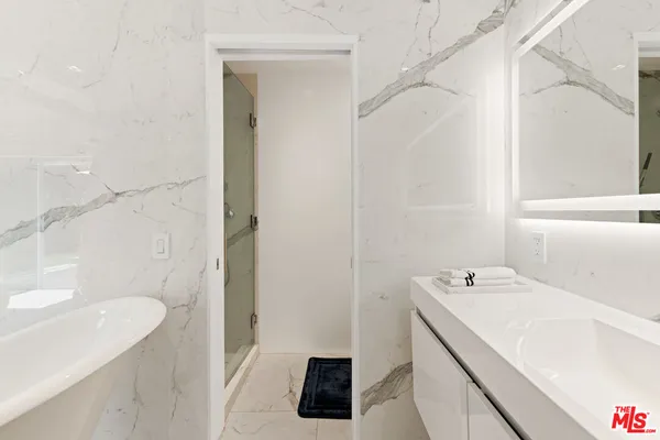 a bathroom with a sink a vanity and a bathtub