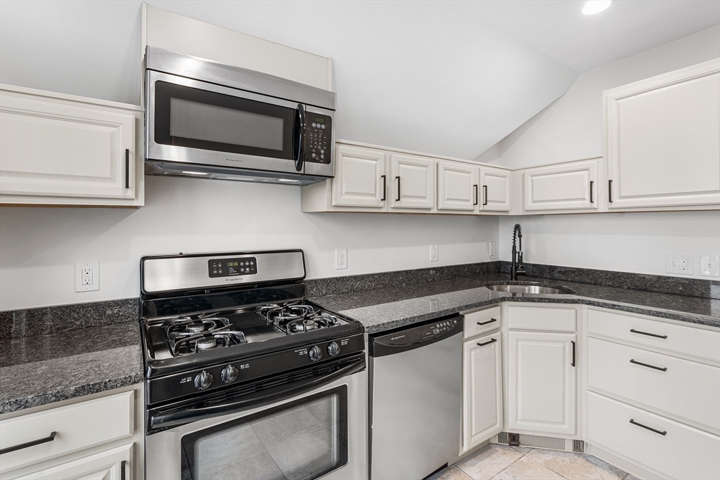 280 Broadway, Unit 5 Somerville, MA 02145 - Photo 2 of 13 a kitchen with white cabinets and appliances