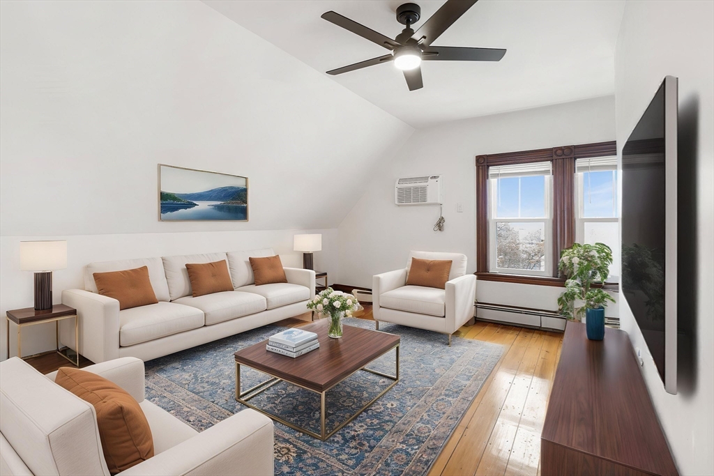 280 Broadway, Unit 5 Somerville, MA 02145 - Photo 5 of 13 a living room with furniture and a large window