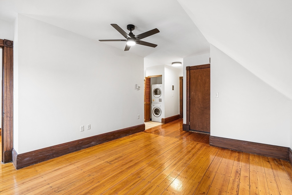 280 Broadway, Unit 5 Somerville, MA 02145 - Photo 6 of 13 a view of empty room with wooden floor and fan